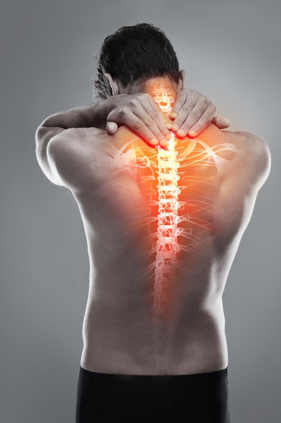 A man seen from the back, holding his neck, with a glowing visual of his spine highlighting potential pain areas in red and orange. He appears to have back issues or discomfort.
